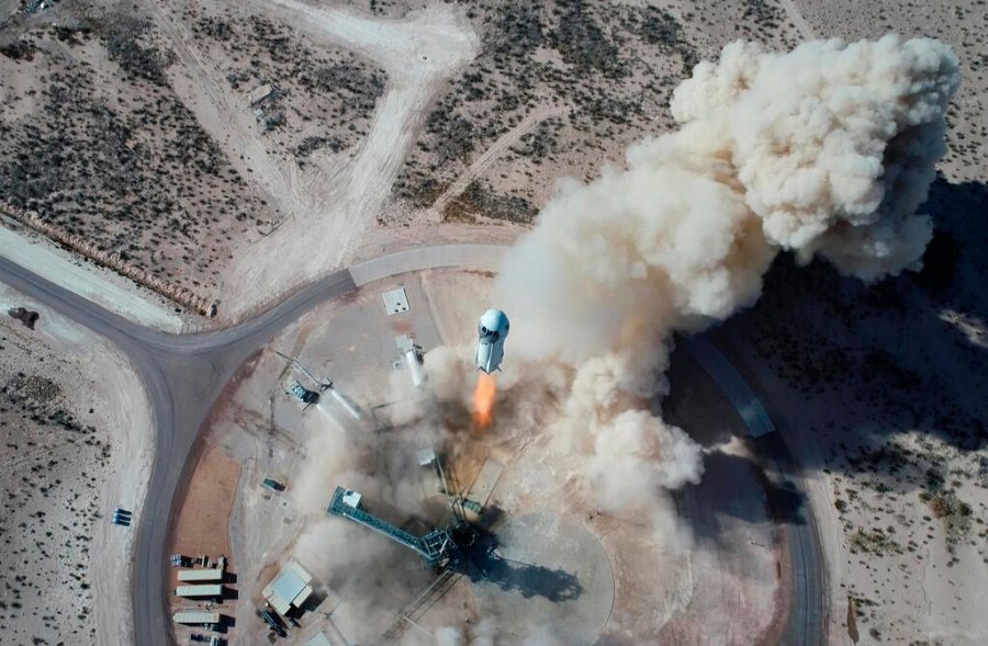 In this photo made available by Blue Origin, the New Shepard NS-14 rocket lifts off from Launch Site One in West Texas on Jan. 14, 2021. On Tuesday, July 20, 2021, Blue Origin’s 60-foot New Shepard rocket will accelerate toward space at three times the speed of sound, or Mach 3, before separating from the capsule and returning for an upright landing. (Blue Origin via AP)